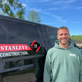 wesley johnson standing near stanley ink construction truck